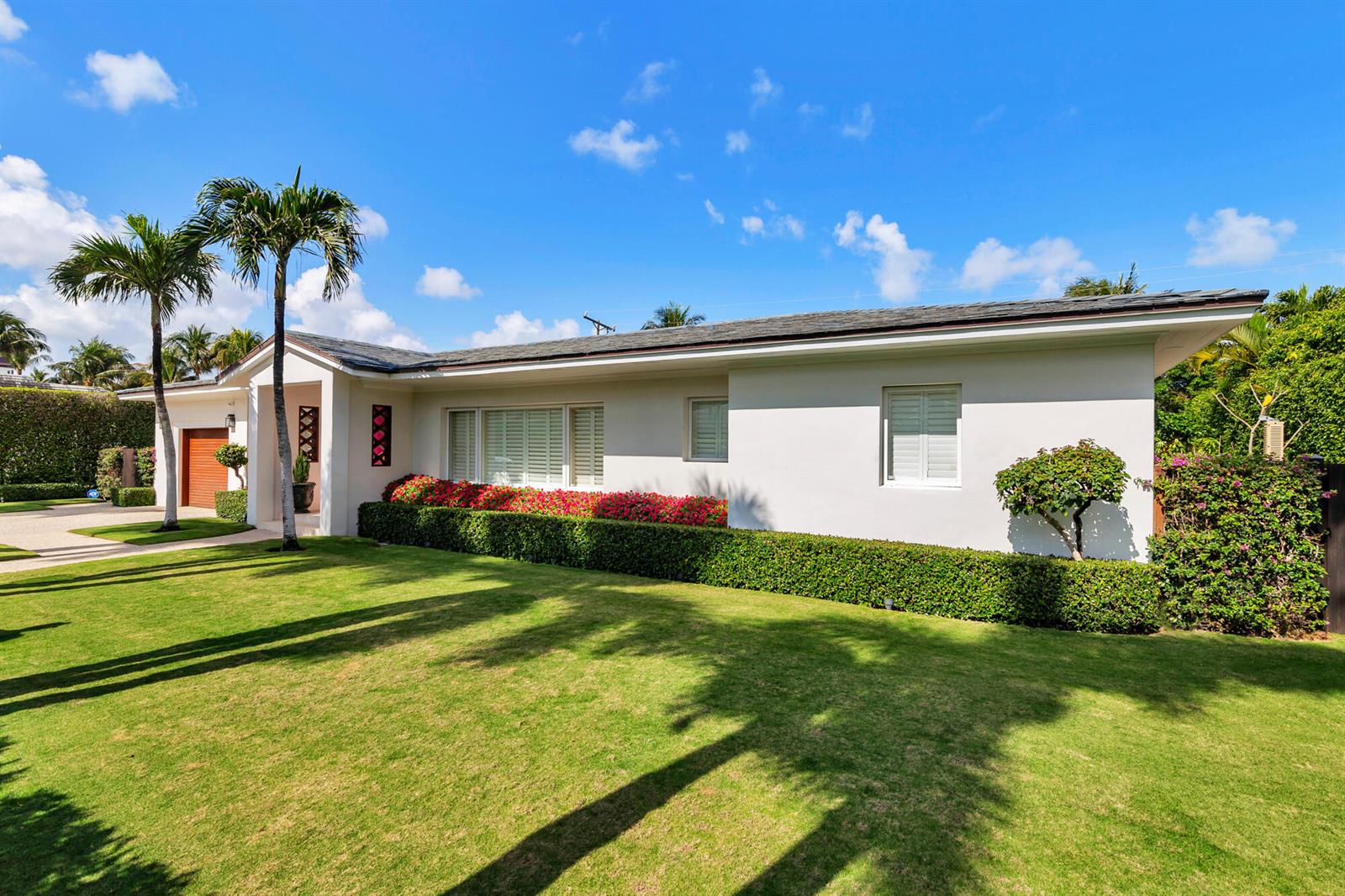 A white single-story house with a manicured lawn, palm trees, and a hedge-lined garden — 225 Jamaica Lane, Palm Beach FL 33480, PALM BEACH, FL
