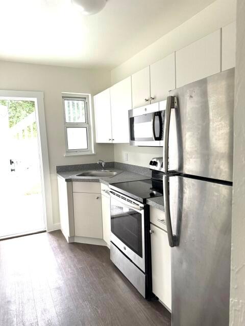 An empty bedroom features white walls, a ceiling fan, and hardwood flooring — 715 2nd Avenue S # 3, FL 33460, FL