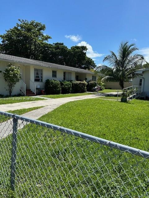 A single-story residential building with a concrete walkway and a chain-link fence in front — 470 NW 26th Ave, Miami FL 33125, MIAMI, FL