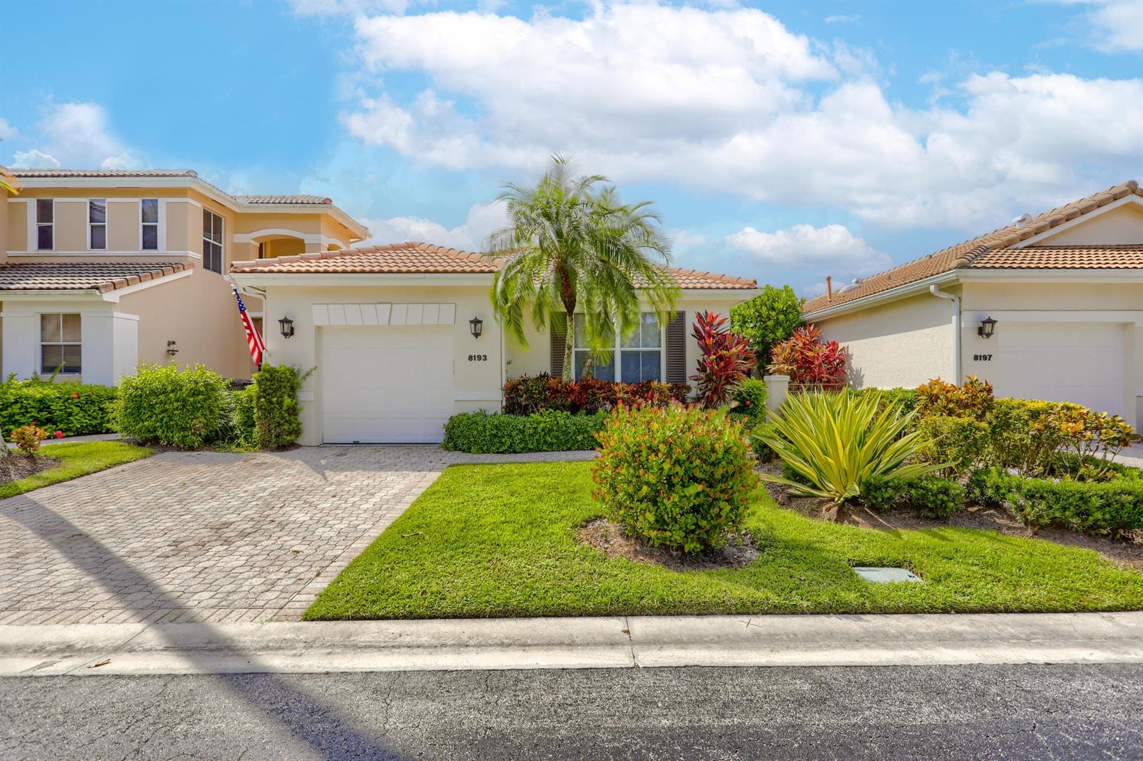 A single-story house with a paved driveway, a one-car garage, and landscaped front yard — 8193 Sandpiper Way, West Palm Beach FL 33412, WEST PALM BEACH, FL