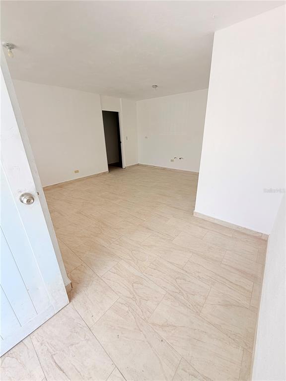 An empty room with white walls and light-colored tile flooring features a doorway — Calle 601 BLOQUE 224 COMERCIAL 2, CAROLINA, PR