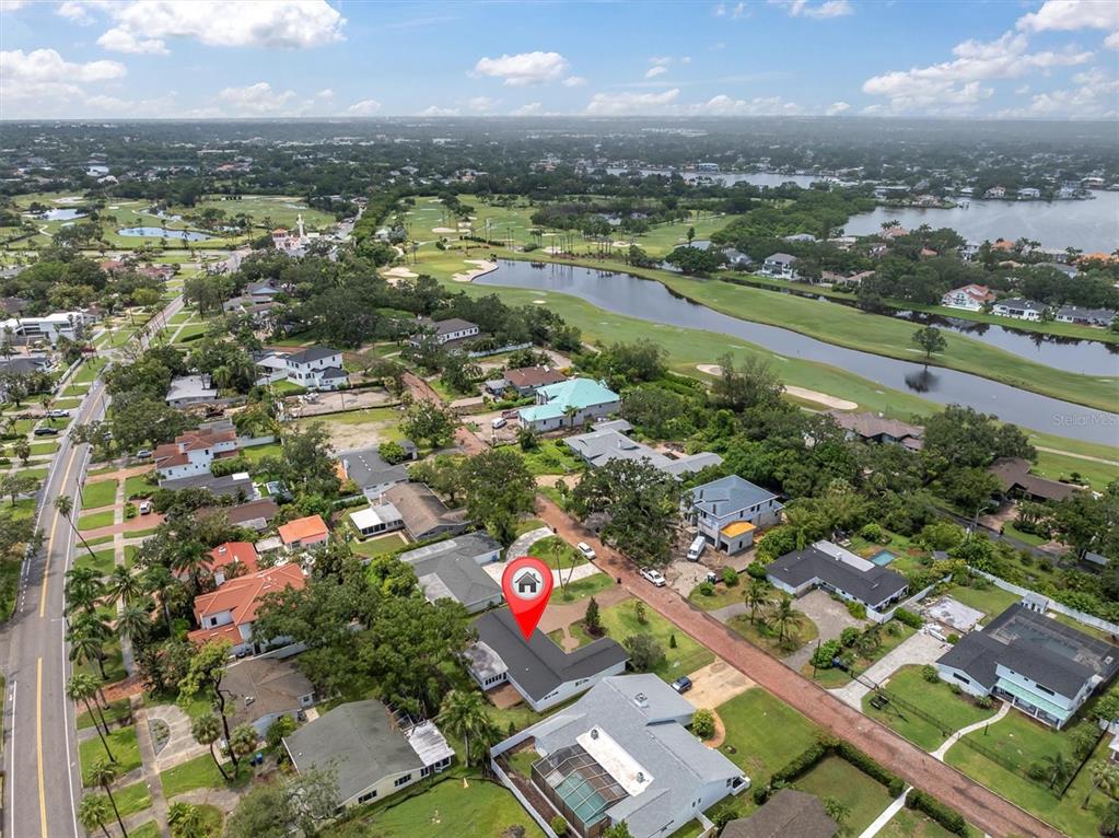 An aerial view shows a residential neighborhood with a marked house near a golf course — 319 RAFAEL BOULEVARD NE, ST PETERSBURG, FL