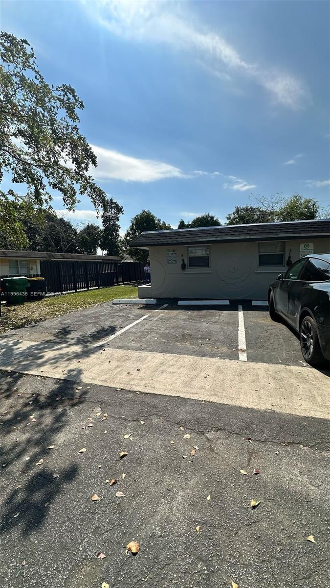 A paved parking area sits in front of a single-story building with two windows — 715 SW 6th St, Dania Beach FL 33004, DANIA BEACH, FL