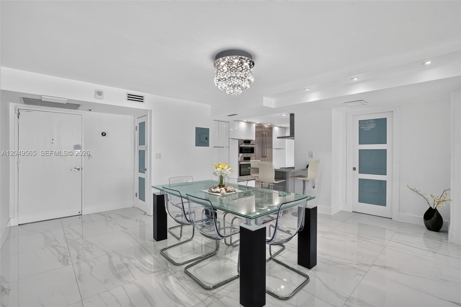 An aerial view shows a large beachfront apartment building surrounded by other high-rise structures — 6039 Collins Ave # 1624, Miami Beach FL 33140, MIAMI BEACH, FL