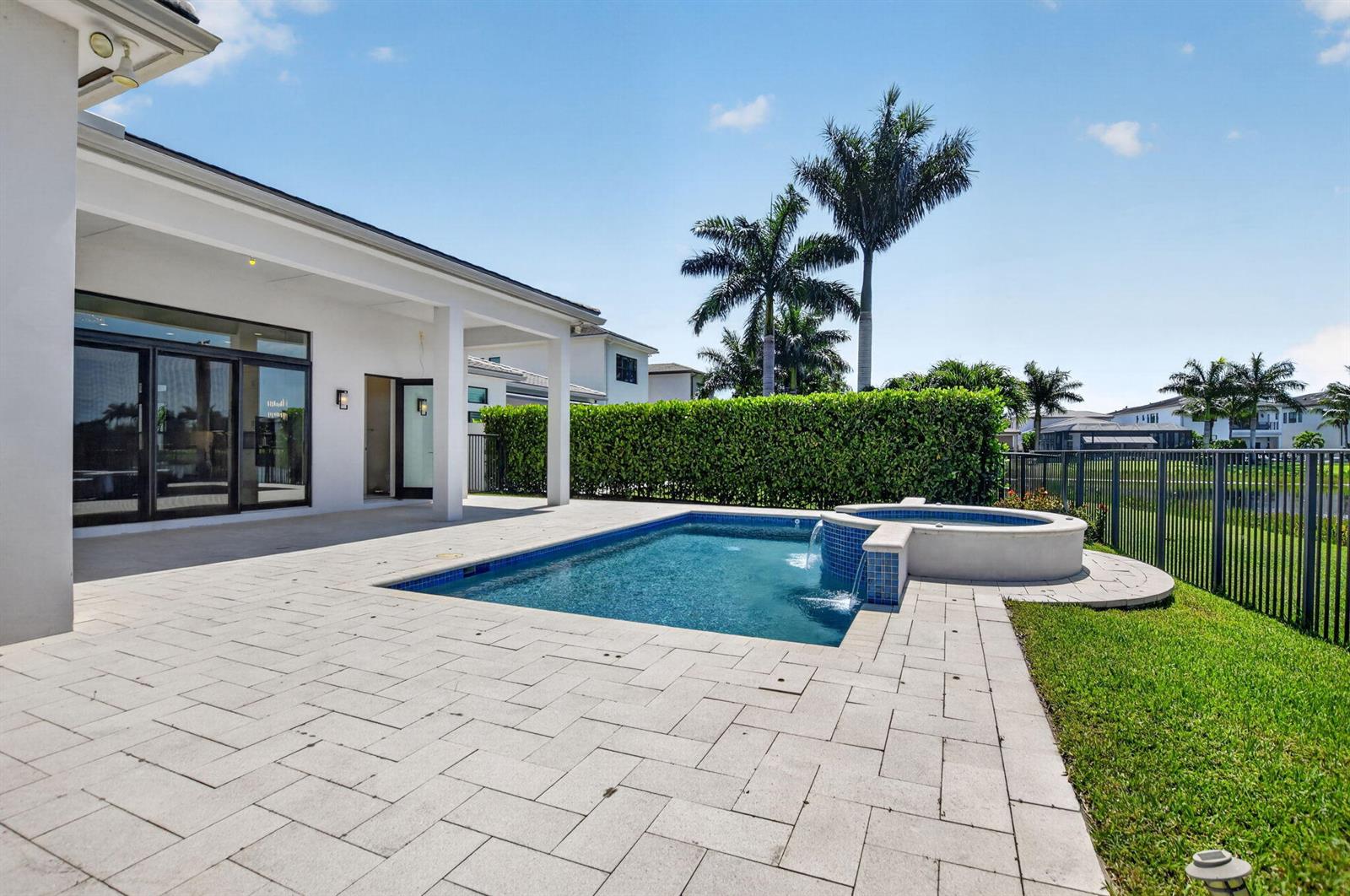 A backyard patio features a rectangular swimming pool with an attached circular spa and fountain — 9168 Benedetta Place, Boca Raton FL 33496, BOCA RATON, FL