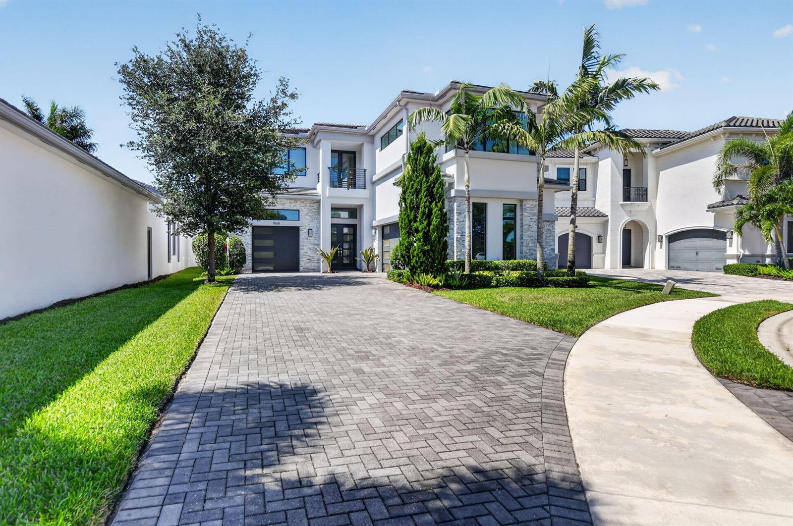 A two-story modern house with a paved driveway, palm trees, and a multi-car garage — 9168 Benedetta Place, Boca Raton FL 33496, BOCA RATON, FL