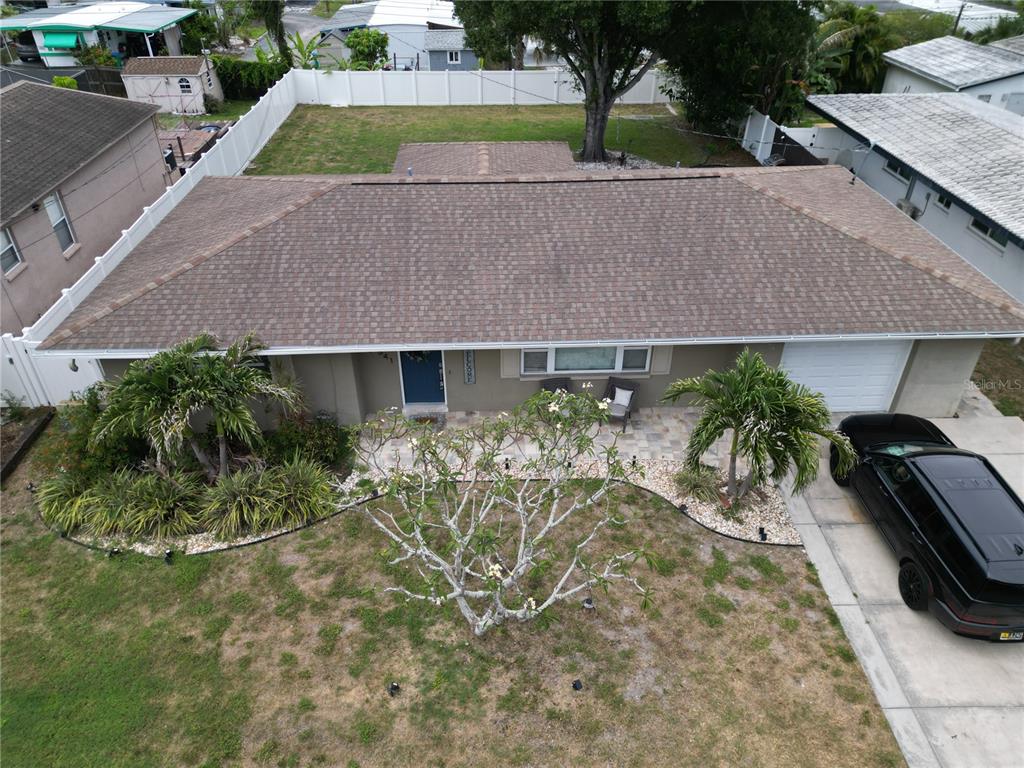 An aerial view shows a single-story house with a brown shingled roof and a driveway — 10541 86TH AVENUE, SEMINOLE, FL
