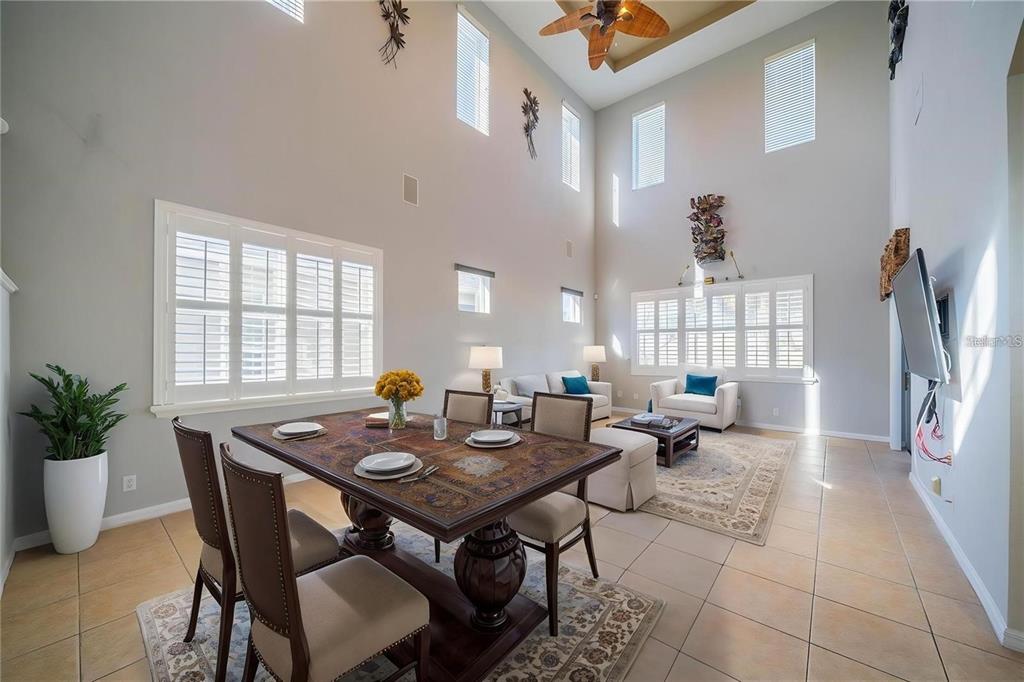 A kitchen with wood cabinets, granite countertops, stainless steel appliances, and beige tile flooring — 445 NOBLE FAIRE DRIVE, SUN CITY CENTER, FL