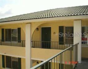An exterior view of a multi-story building with yellow stucco walls and metal railings — 151 OYSTER BAY CIRCLE UNIT 300, ALTAMONTE SPRINGS, FL