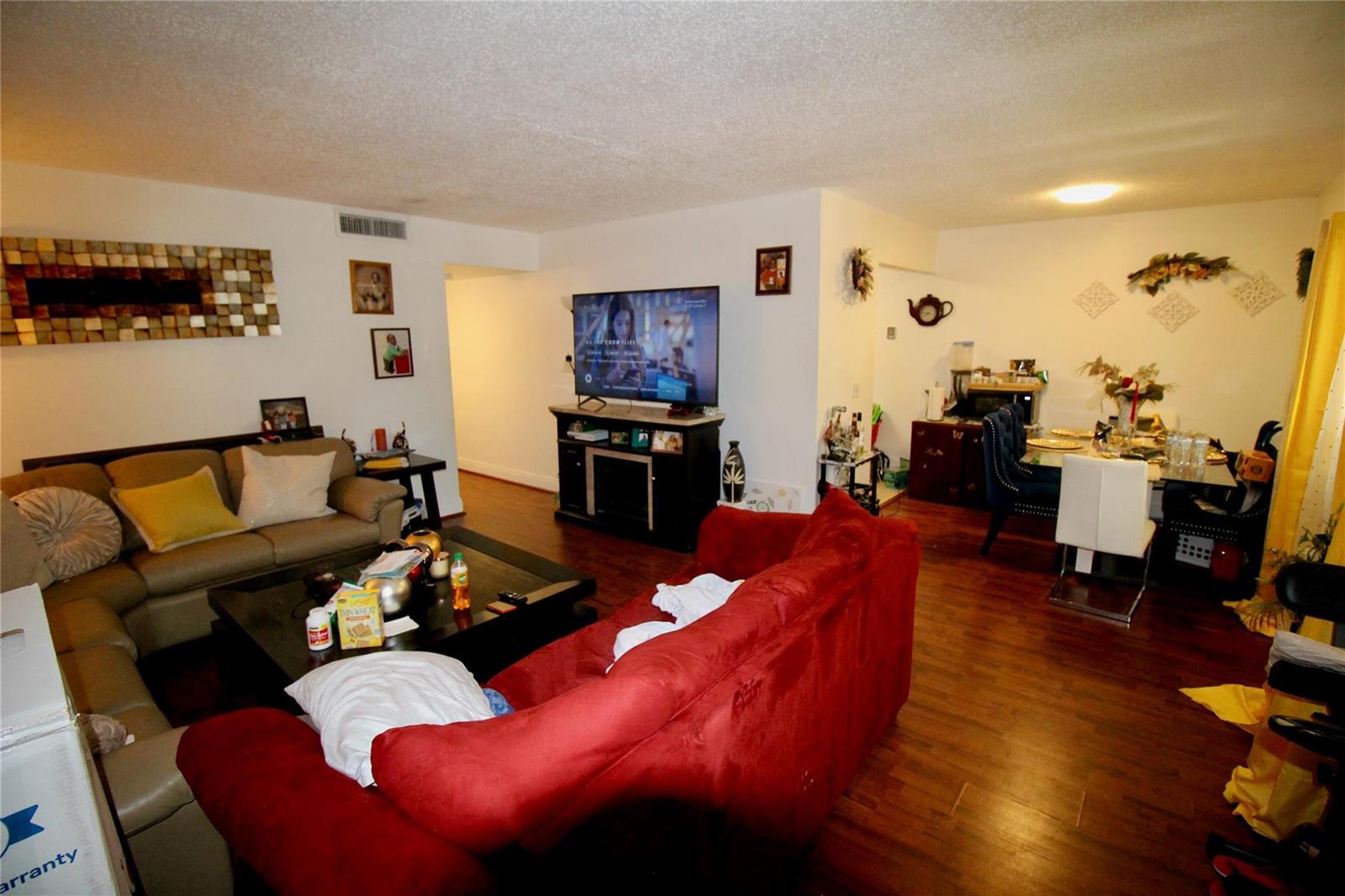 A living room and dining area with hardwood floors, two sofas, and a television — 316 Meadows Circle # 316, Boynton Beach FL 33436, BOYNTON BEACH, FL