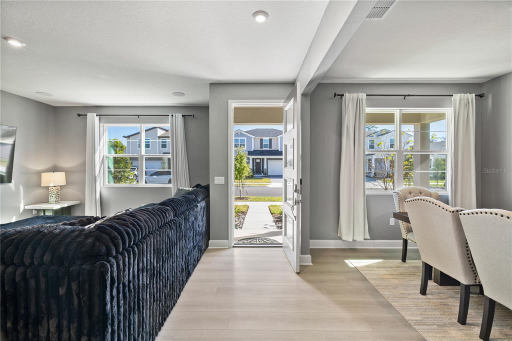 A view from inside a home looking through an open front door toward a neighborhood — 13058 PERGOLA AVENUE, ORLANDO, FL