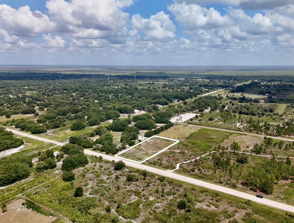 An aerial view shows a rectangular vacant lot outlined in white along a paved road — 18277 NW 304TH STREET, OKEECHOBEE, FL