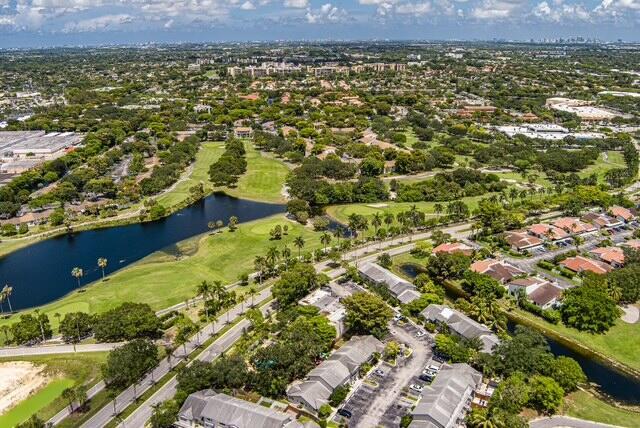 An aerial view shows a golf course with a lake surrounded by residential buildings — 8327 Fairway Road # 8327, Sunrise FL 33351, SUNRISE, FL
