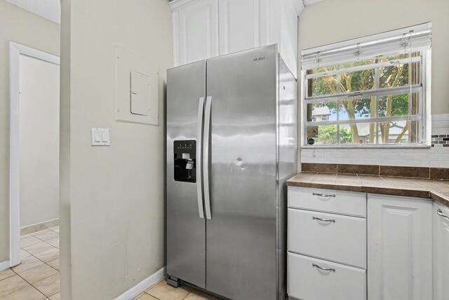 A stainless steel refrigerator stands next to white cabinets and a window in a kitchen — 8327 Fairway Road # 8327, Sunrise FL 33351, SUNRISE, FL