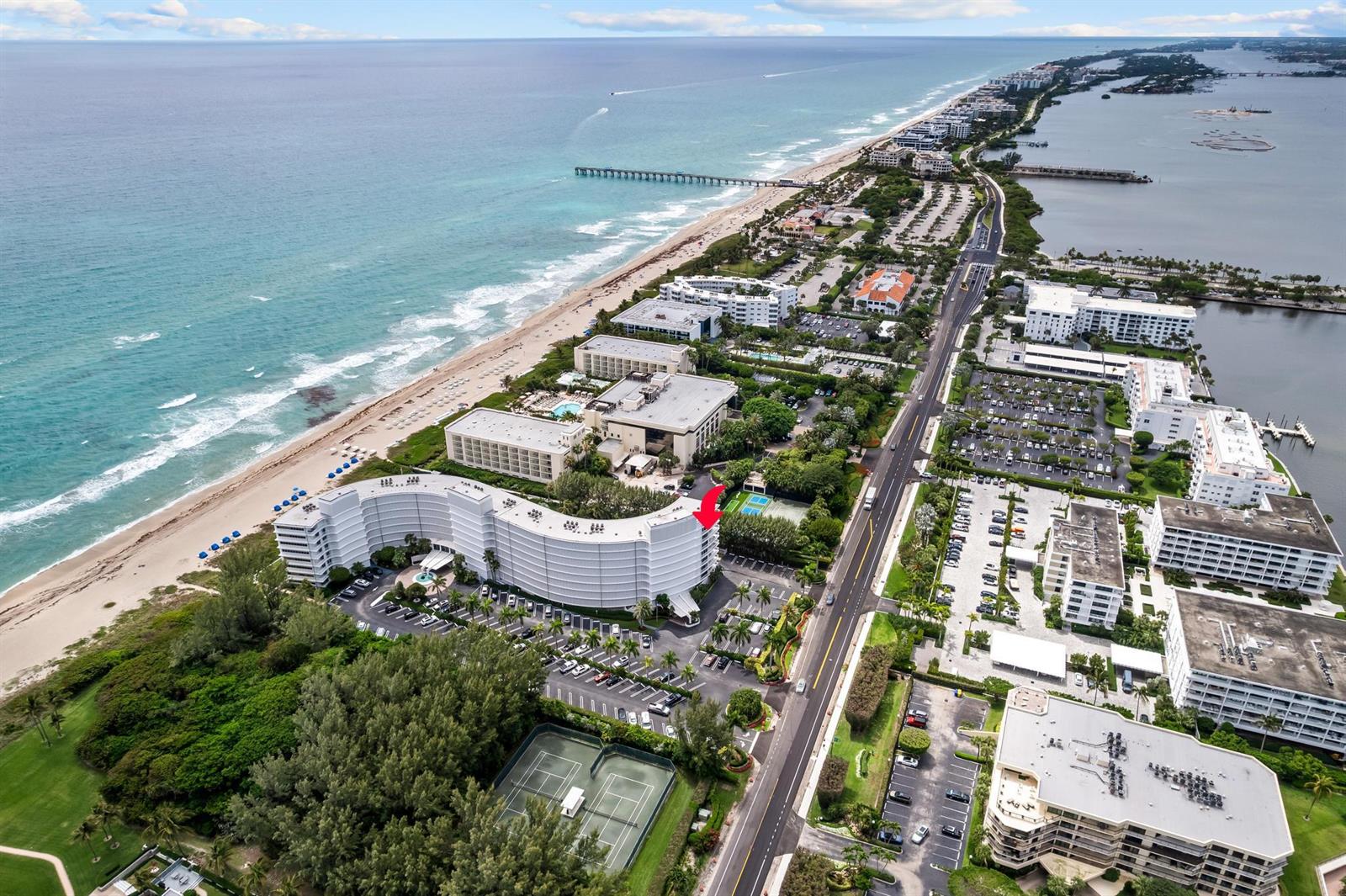 An aerial view shows a curved beachfront hotel with a red arrow pointing toward it — 2780 S Ocean Boulevard # 612, Palm Beach FL 33480, PALM BEACH, FL