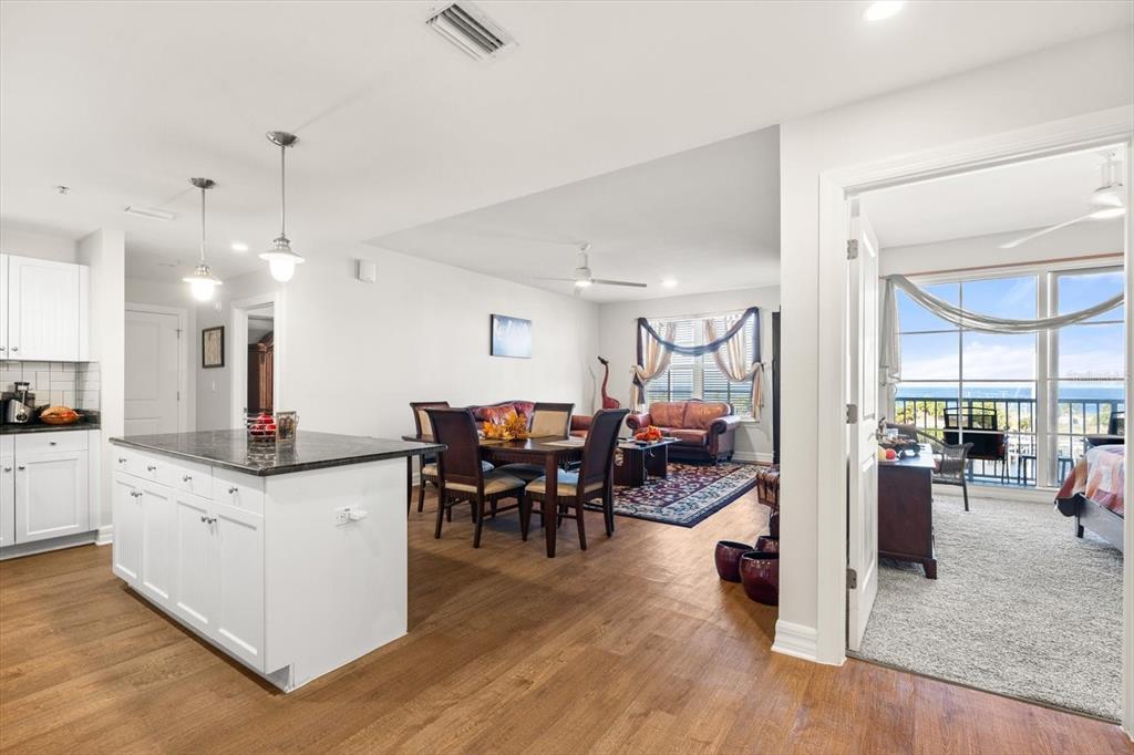 An open-concept kitchen and dining area leads to a living room and a balcony view — 536 BAHIA BEACH BOULEVARD UNIT 503A, RUSKIN, FL