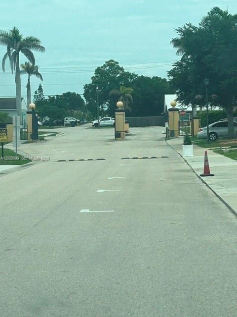 This exterior view shows a gated entrance with speed bumps and a traffic cone — 1497 Las Villas Blvd, Sebring FL 33870, SEBRING, FL