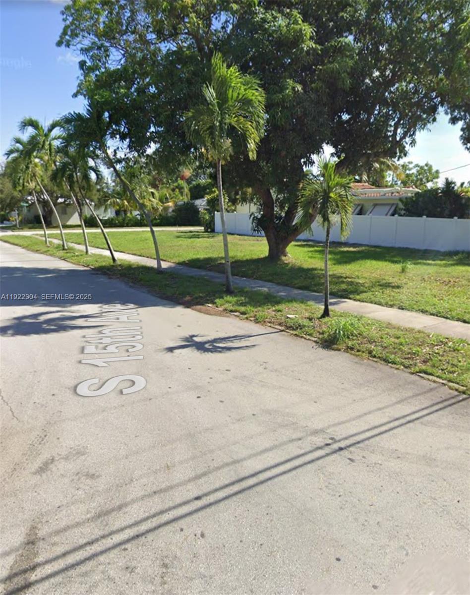 A street view shows a grassy lot lined with palm trees and a white fence — 1452 Jefferson St, Hollywood FL 33020, HOLLYWOOD, FL