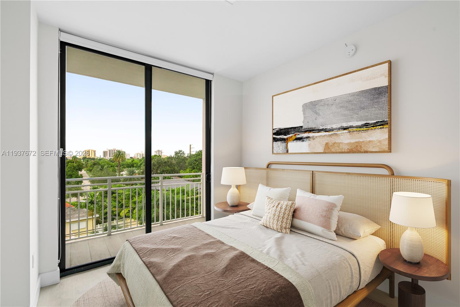 A bedroom features a cane headboard, two bedside lamps, and a balcony with a city view — 1601 SW 32 Avenue # 313, Miami FL 33145, MIAMI, FL