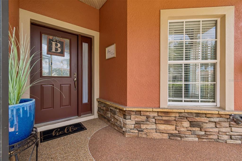 A front entryway features a brown door with a letter B, a window, and stone siding — 218 BAY DRIVE, KISSIMMEE, FL