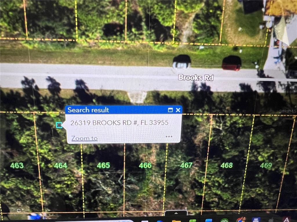 This is a satellite map view showing a road and several numbered land parcels — 26319 BROOKS ROAD, PUNTA GORDA, FL