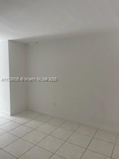 An empty room with white walls and light-colored square floor tiles — 1441 Lincoln Rd # 414, Miami Beach FL 33139, MIAMI BEACH, FL