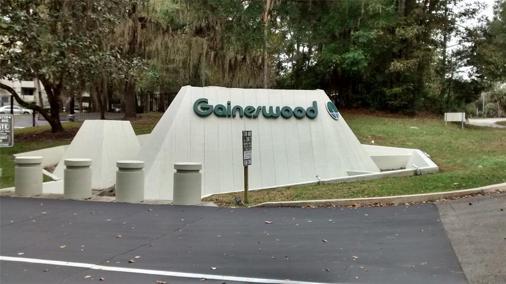 A concrete monument sign for Gainerwood stands at the entrance of a residential property — 1719 NW 23RD AVENUE UNIT 5A, GAINESVILLE, FL