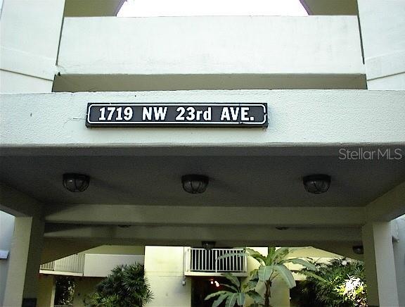 A street address sign is mounted on the exterior wall above a covered building entrance — 1719 NW 23RD AVENUE UNIT 5A, GAINESVILLE, FL