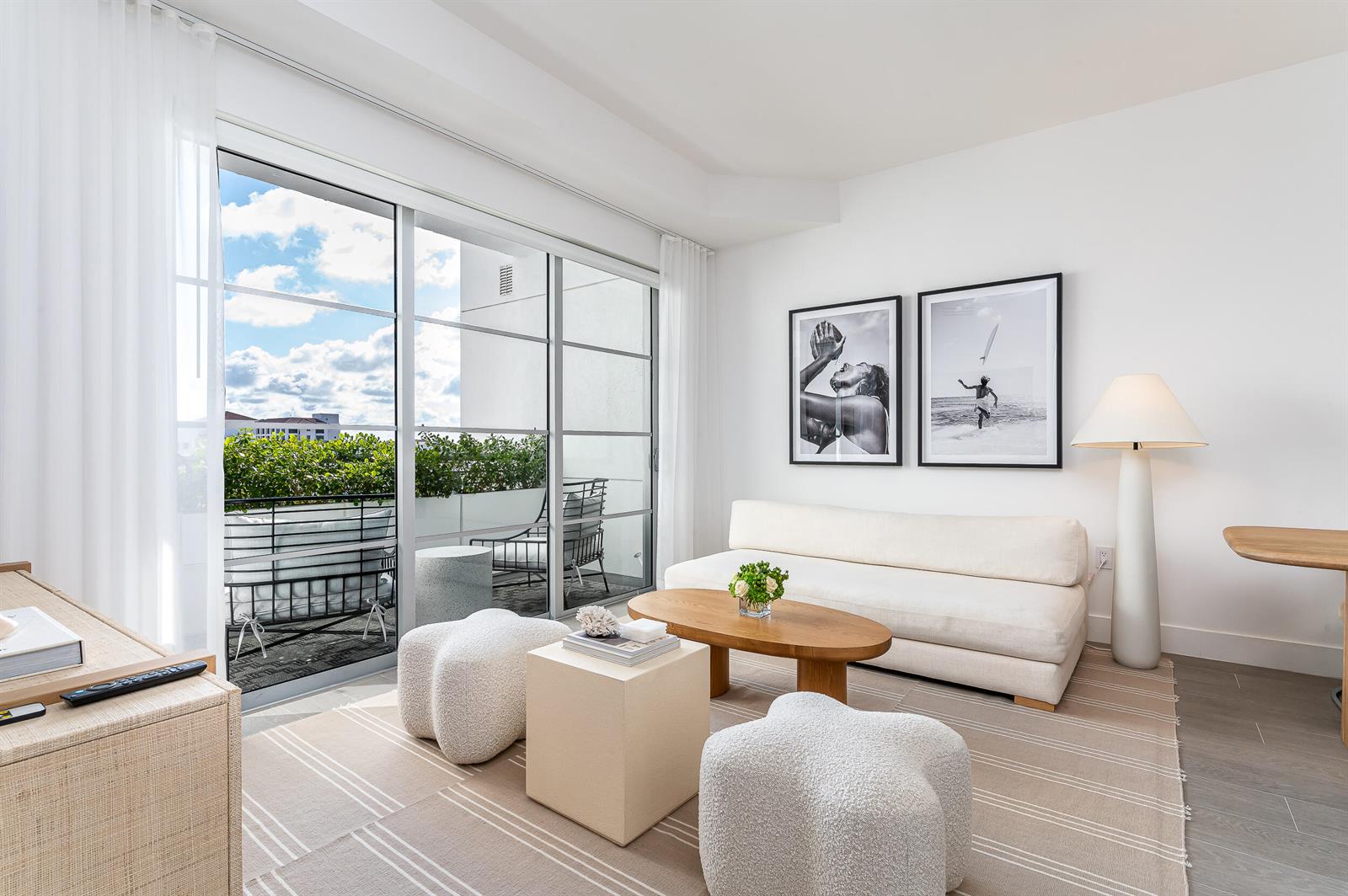 A modern living room features a white sofa, wooden coffee table, and a balcony view — 155 E Boca Raton Road # 1008, Boca Raton FL 33432, BOCA RATON, FL