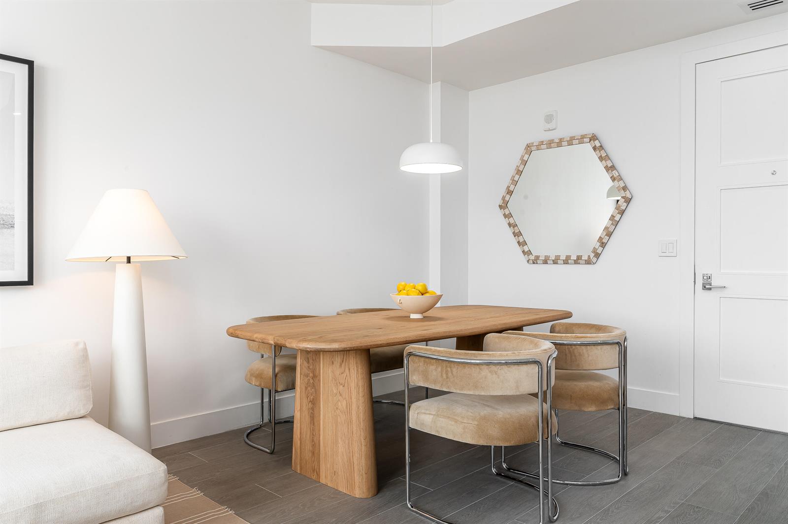 A dining area features a wooden table, four velvet chairs, a pendant light, and a mirror — 155 E Boca Raton Road # 1008, Boca Raton FL 33432, BOCA RATON, FL