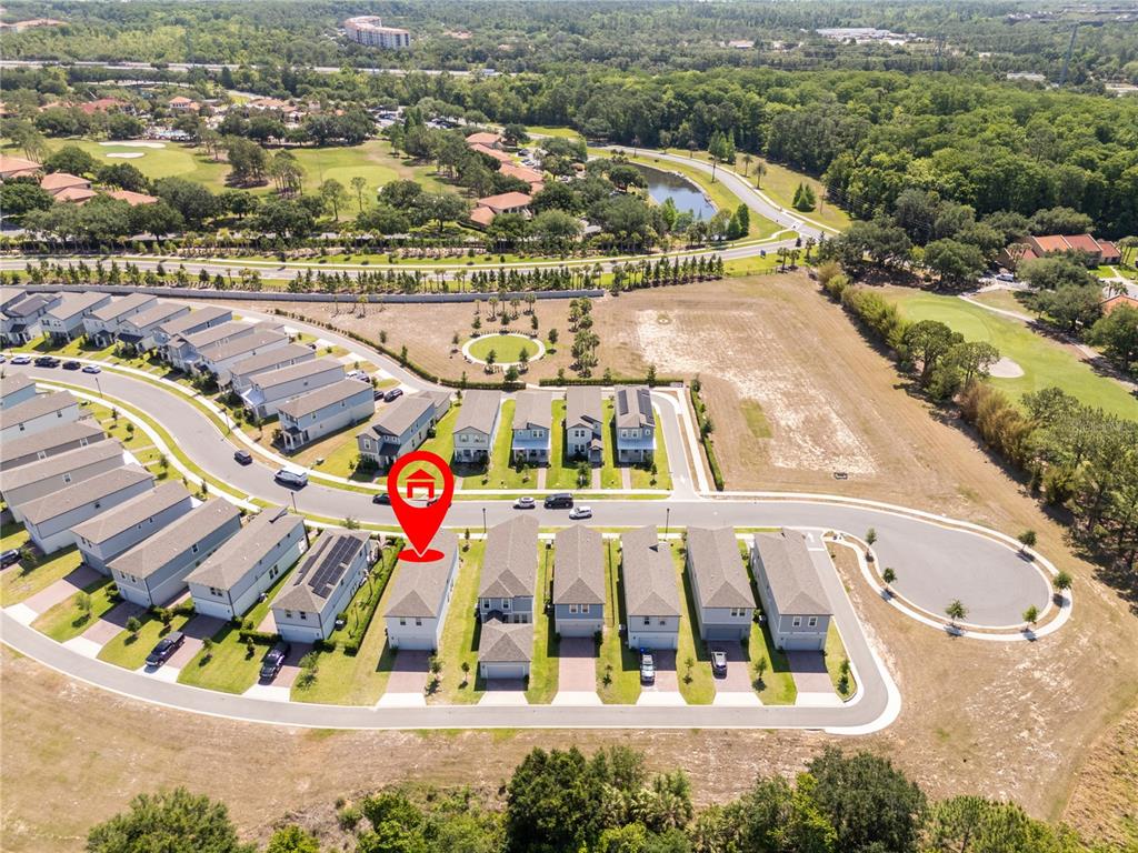 An aerial view shows a suburban neighborhood with a marked house and golf course — 12362 BRACCO STREET, WINTER GARDEN, FL