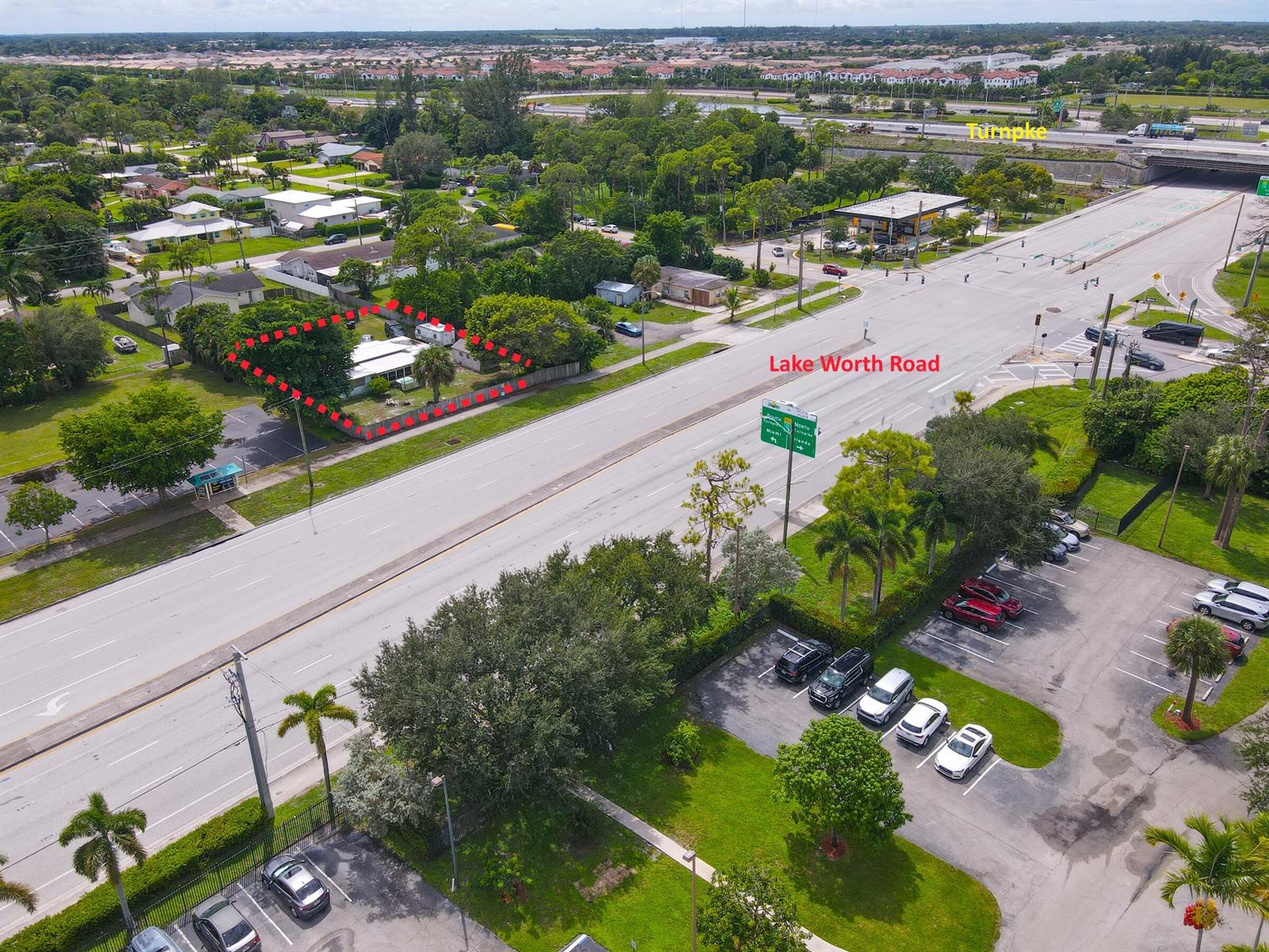 An aerial view shows a residential property outlined in red along a multi-lane road — 122 Springdale Road, FL 33467, FL