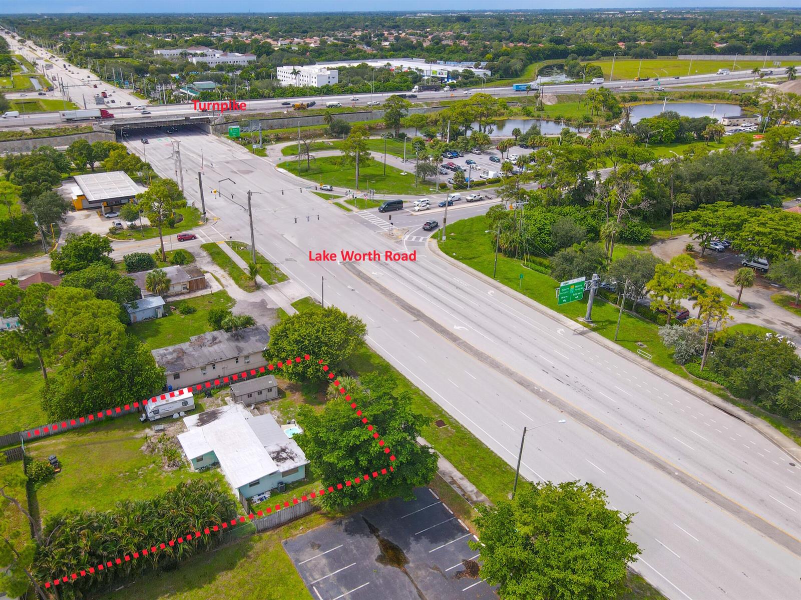 An aerial view shows a single-story house with a red-outlined lot bordering a major road — 122 Springdale Road, FL 33467, FL