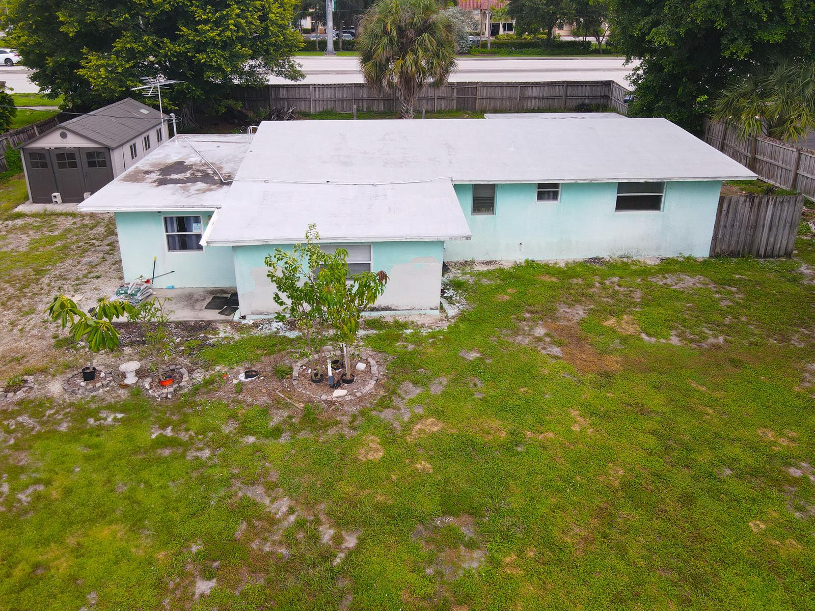 An aerial view of a light blue house with a white roof and a shed — 122 Springdale Road, FL 33467, FL