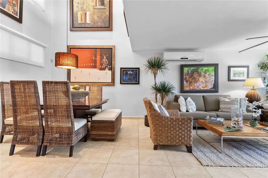 A dining area with wicker chairs and a living room with a sofa and coffee table — 285 PALMAS INN WAY CORNER SE UNIT 1303, HUMACAO, PR