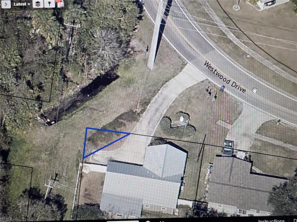 An aerial map view shows a residential property lot with a house and driveway — 0 WESTWOOD DRIVE, TITUSVILLE, FL