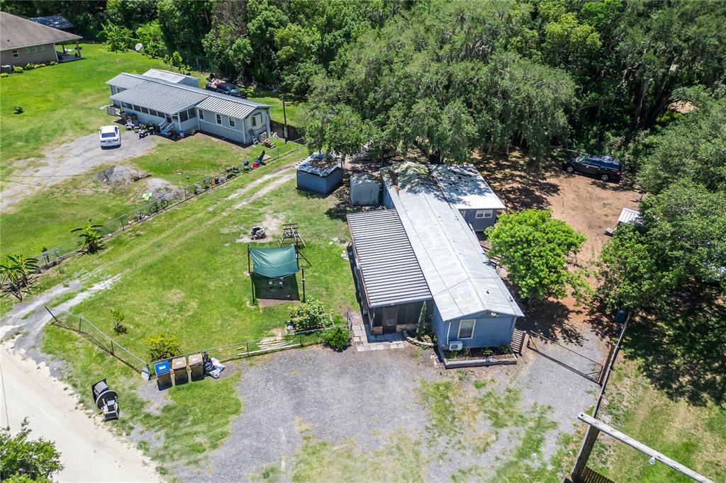 An aerial view shows two mobile homes on a large, grassy lot with trees — 4960 YUKON STREET, ST CLOUD, FL