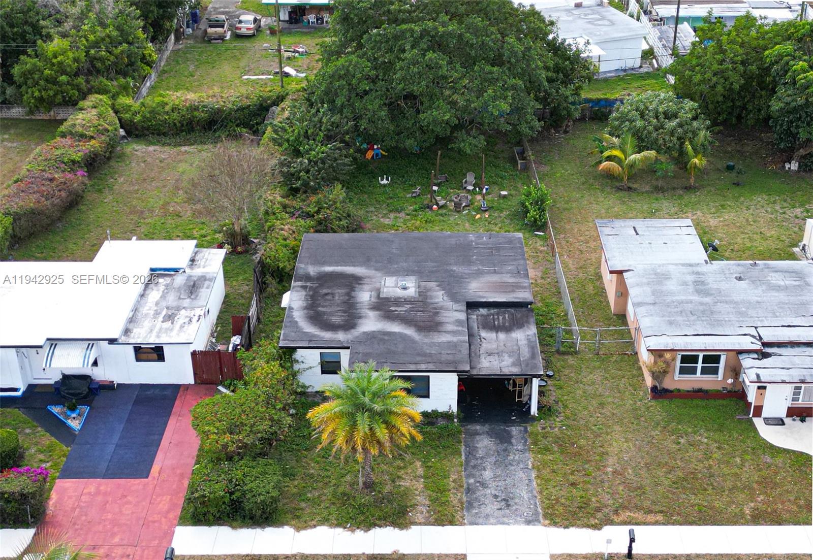 An aerial view shows a single-story house with a flat roof and a large backyard — 5844 Garfield St, Hollywood FL 33021, HOLLYWOOD, FL