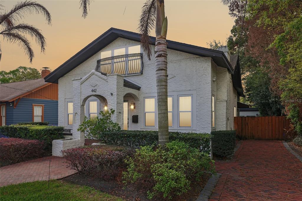 A white stucco house with a brick driveway and a small balcony above the entrance — 442 BRIERCLIFF DRIVE, ORLANDO, FL