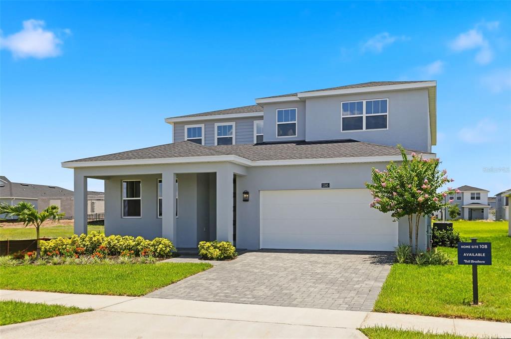 A two-story gray house with a two-car garage and a paved driveway — 1595 STONECLIFFF DRIVE, APOPKA, FL