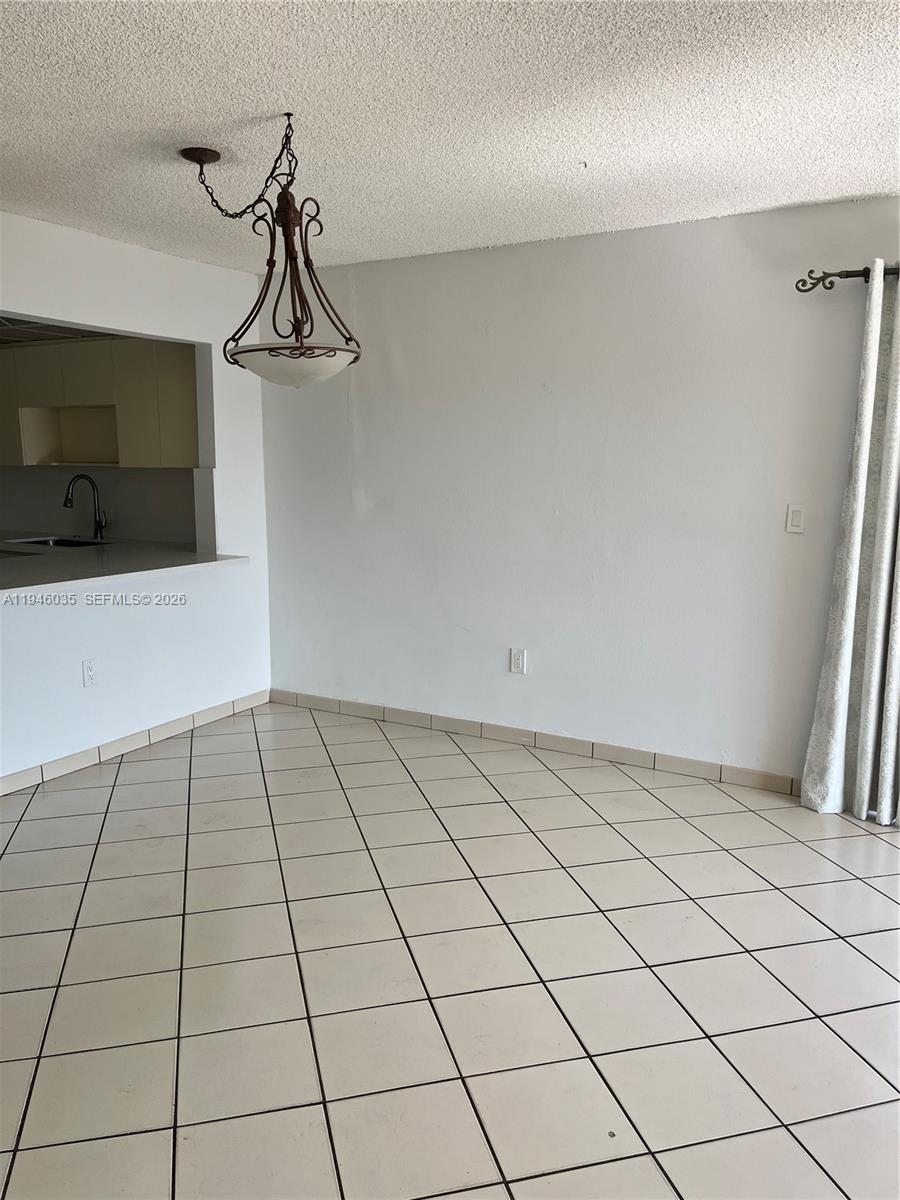 A bedroom features a large television on a grey console, a bed, and a dresser — 6780 W 2nd Ct # 408, Hialeah FL 33012, HIALEAH, FL
