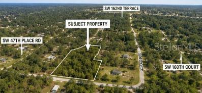An aerial view shows a wooded, undeveloped rectangular lot outlined in white within a residential area — 00 SW 47TH PLACE ROAD, OCALA, FL