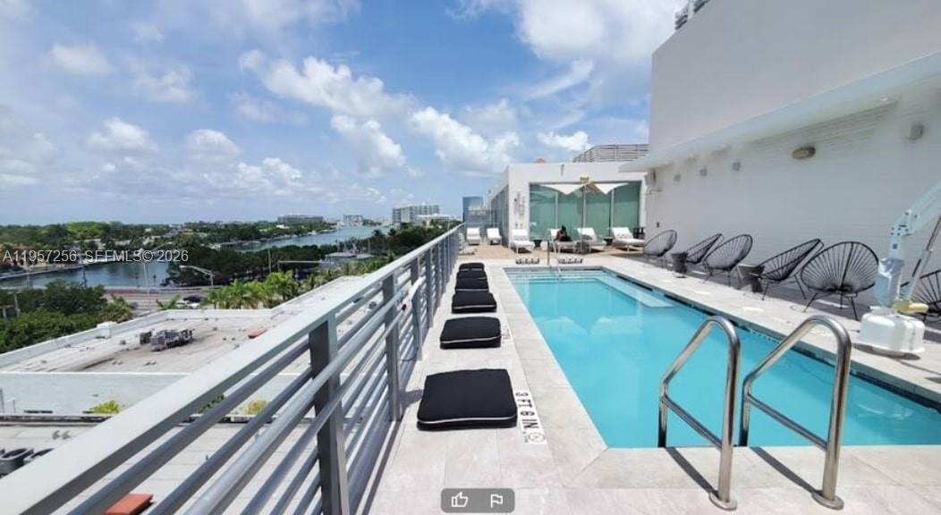 A rooftop swimming pool features lounge chairs and a view of the surrounding area — 6080 Collins Avenue, Miami Beach FL 33140, MIAMI BEACH, FL