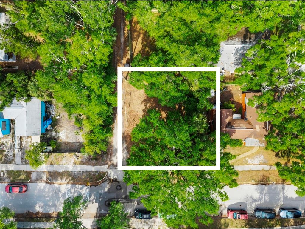 An aerial view shows a vacant, tree-covered residential lot outlined in white — 2715 5TH STREET S, ST PETERSBURG, FL