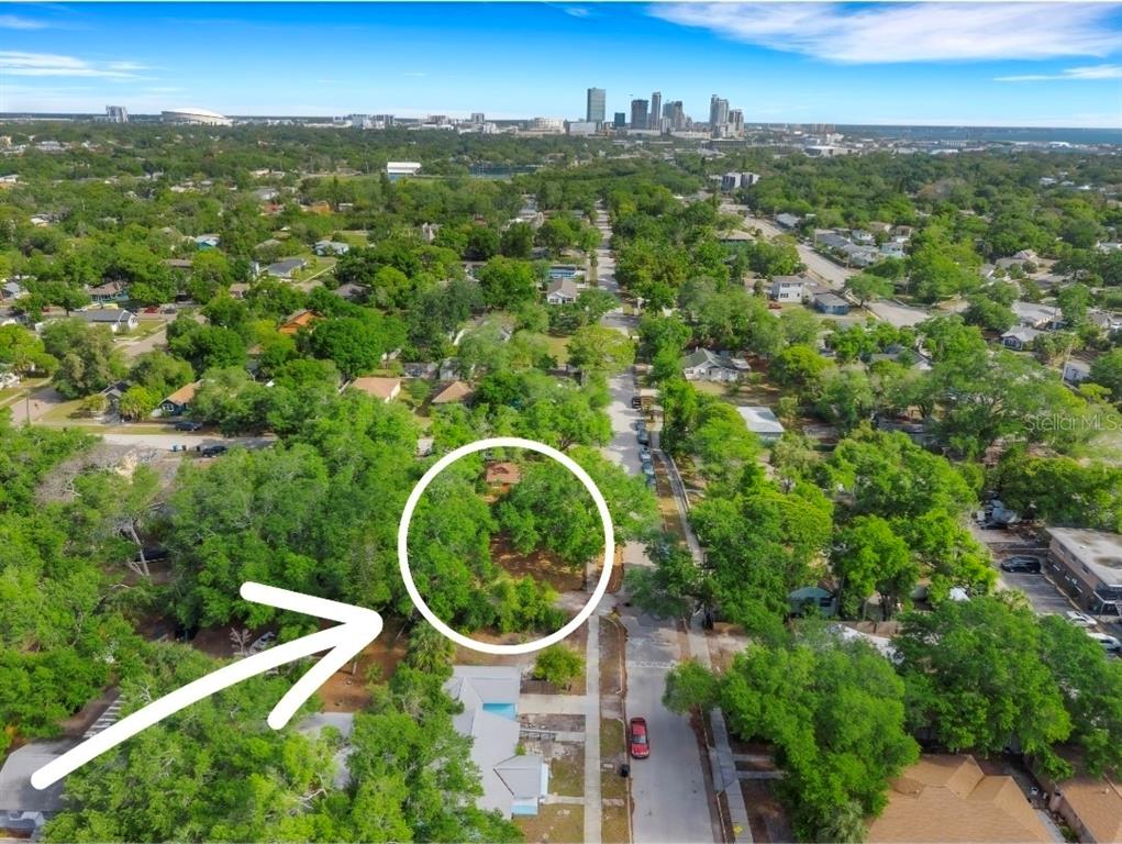 An aerial view shows a wooded, undeveloped residential lot in a suburban neighborhood — 2715 5TH STREET S, ST PETERSBURG, FL