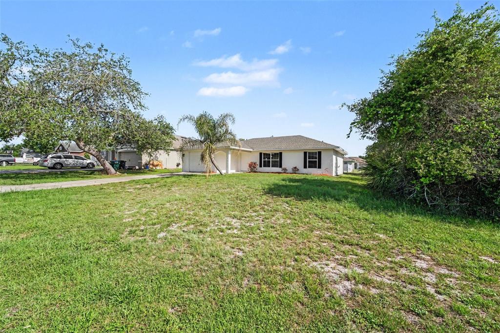 A single-story house with a white exterior, a garage, and a large front lawn — 3156 COVENTRY STREET, DELTONA, FL