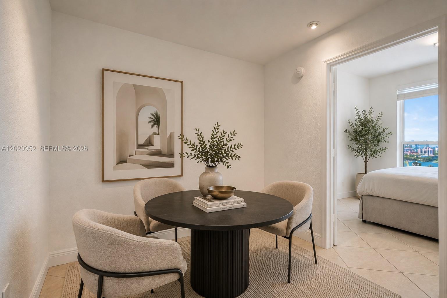 A dining area with a round table and three chairs sits beside a bedroom doorway — 4925 Collins Ave # 3H, Miami Beach FL 33140, MIAMI BEACH, FL