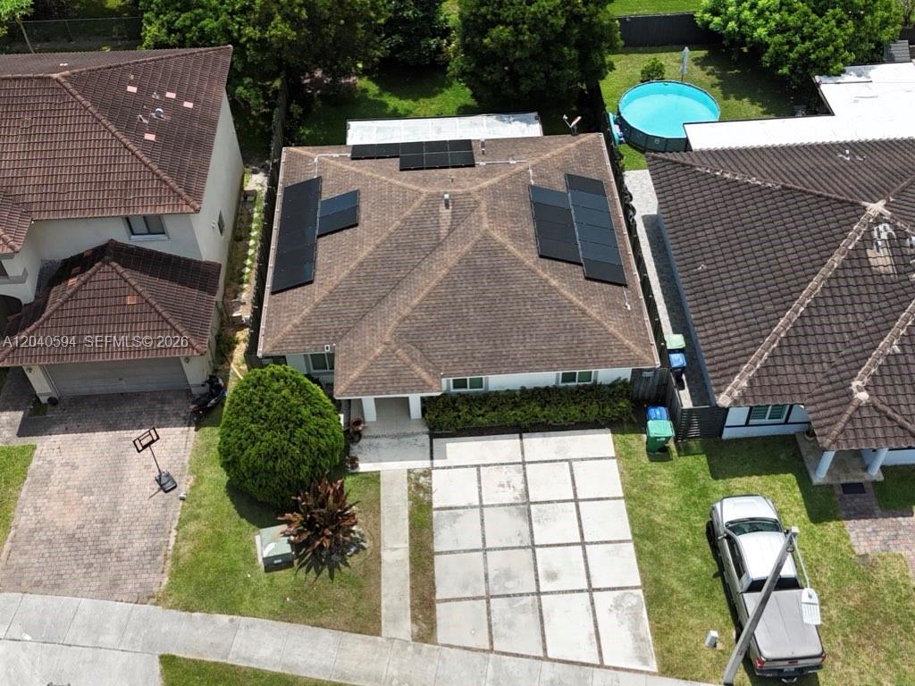 An aerial view shows a house with solar panels on its roof and a backyard pool — 22442 SW 109th Ct, Miami FL 33170, MIAMI, FL