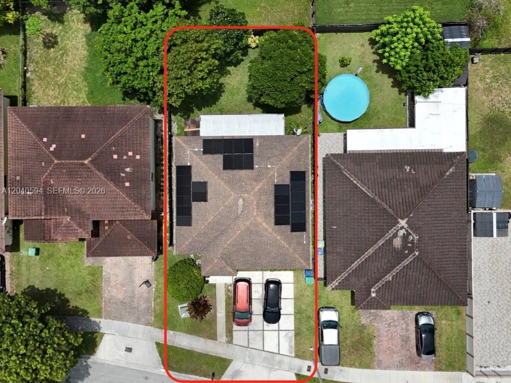An aerial view shows a residential house with solar panels and a backyard with trees — 22442 SW 109th Ct, Miami FL 33170, MIAMI, FL