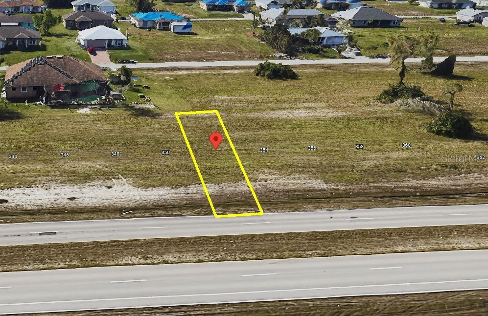 This aerial map shows a vacant rectangular lot outlined in yellow next to a road — 352 DIPLOMAT PARKWAY W, CAPE CORAL, FL